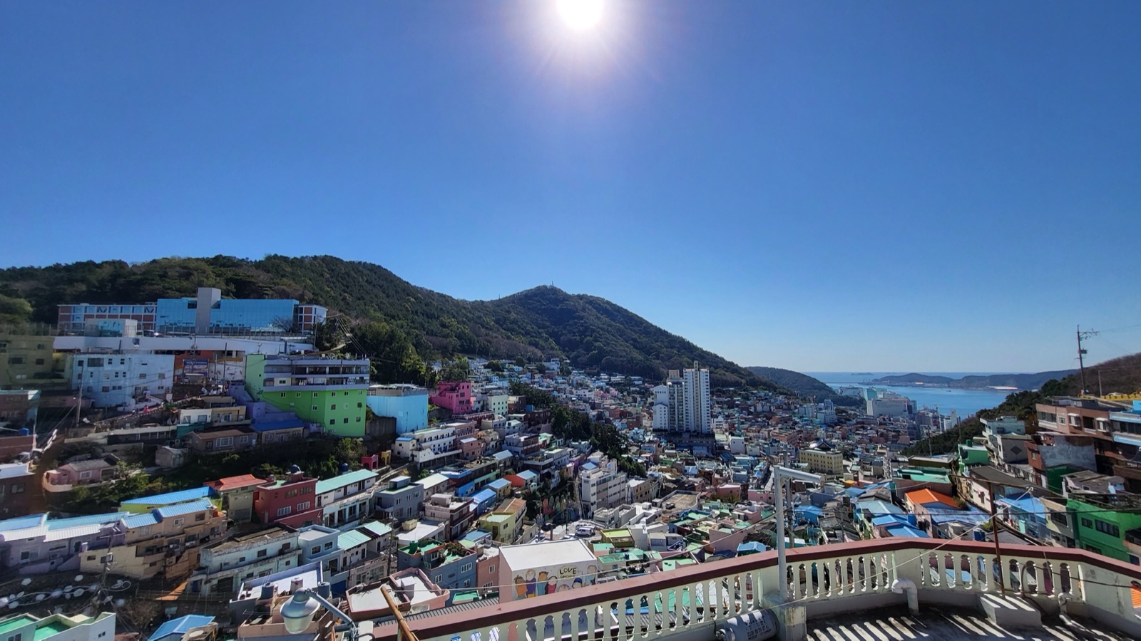 Gamcheon Culture Village in Busan under a blue sky, adding real destination context for first-time Busan planning.